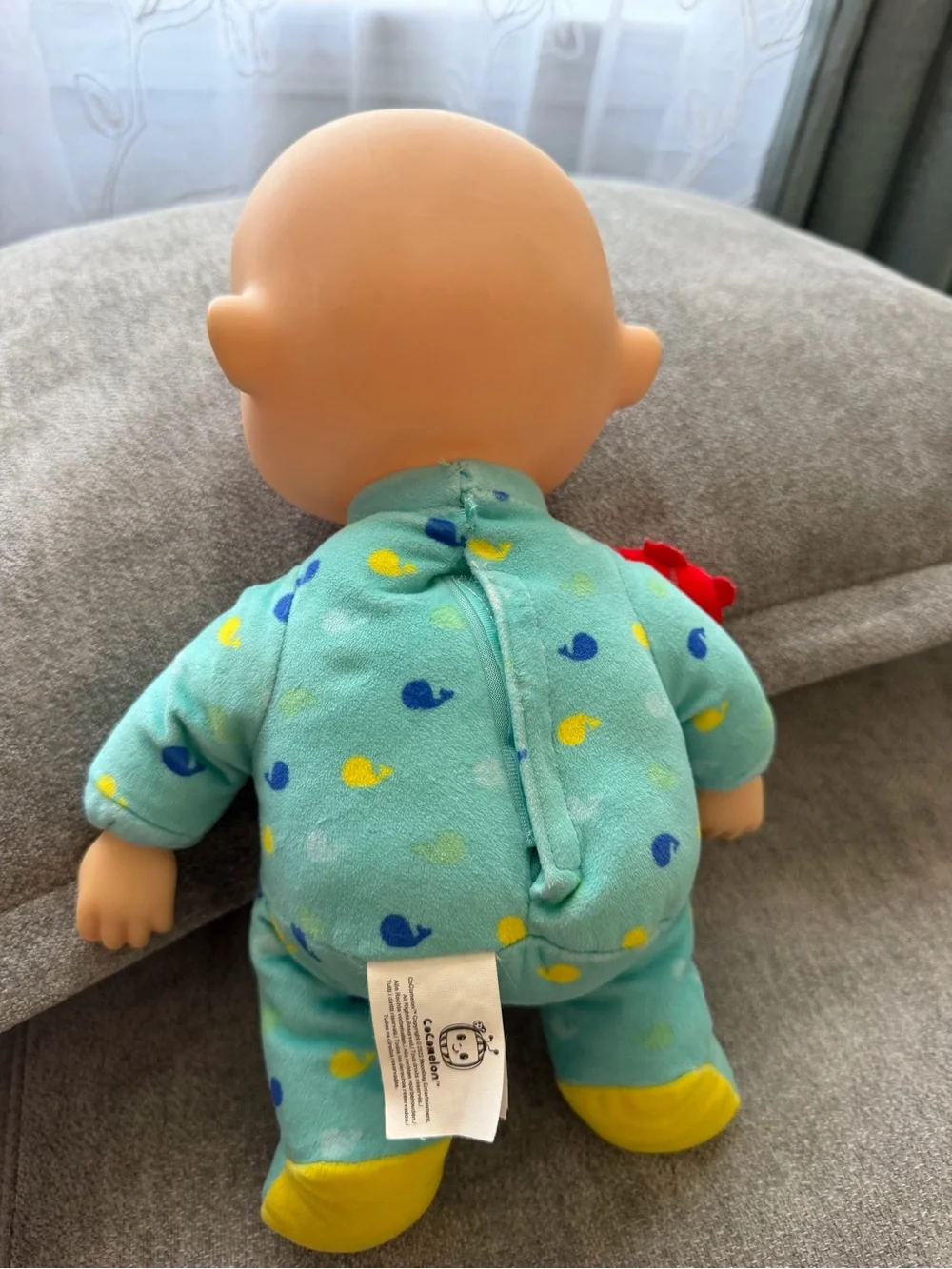 Cocomelon baby doll with blue/yellow duck pattern